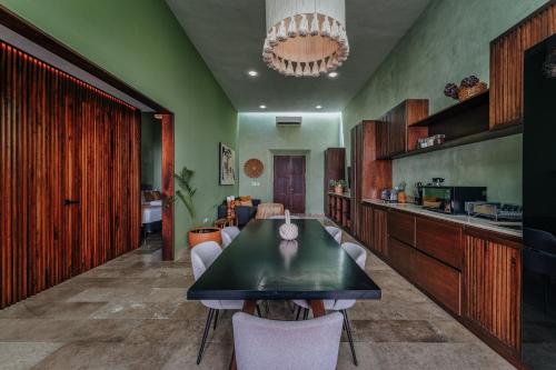 a kitchen and dining room with a table and chairs at Casa Mara 53 Luxury House in downtown Mérida in Mérida