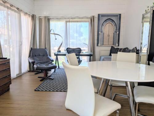 a dining room with a white table and chairs at Guest House in Sydney