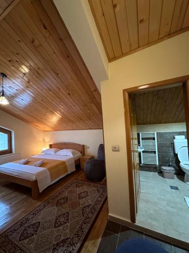 a bedroom with a king sized bed and a bathroom at konaku in Tomin