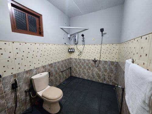 a bathroom with a toilet and a shower at Selsam Haven in Kandapola