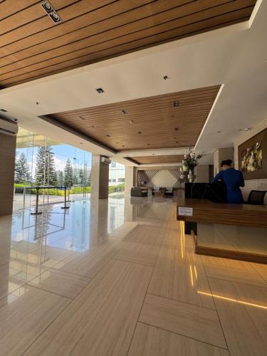 a person sitting on a couch in a living room at Wind Suites Tagaytay Condotel in Tagaytay