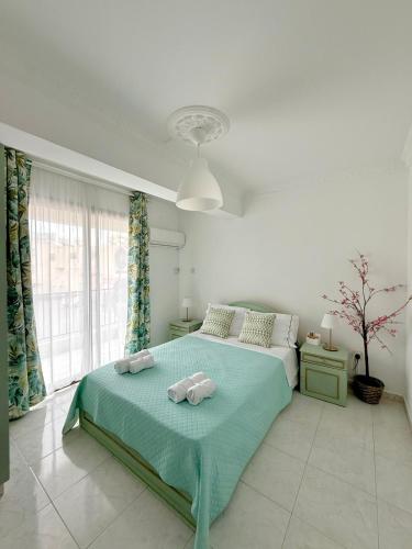 a bedroom with a bed with two stuffed animals on it at Irenes Apartment in Larnaca