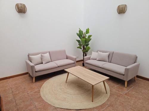 a living room with two couches and a coffee table at Casona IROKO in La Costa
