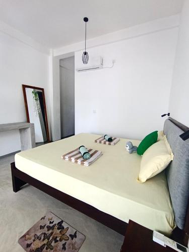 a bed sitting in a room with at Seaware Flowers in Arugam Bay