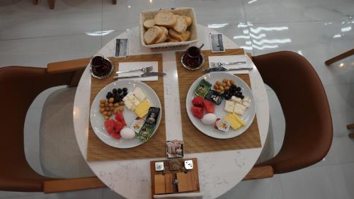 a table with three plates of food on it at Karadeniz Hotel Çorlu in Corlu