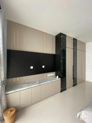 a large kitchen with black and white cabinets at Villa Kila Rengganis Lombok in Prampuan