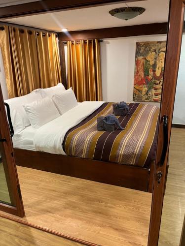 a bedroom with a bed with a wooden frame at Rak Chiang Mai Guesthouse in Chiang Mai