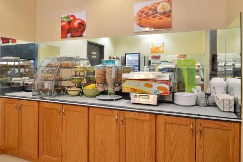 a kitchen with a counter with food on it at Quality Inn & Suites Jefferson City in Jefferson City