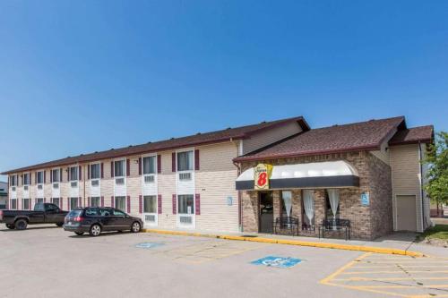 a hotel with a car parked in a parking lot at Super 8 By Wyndham Wayne in Wayne