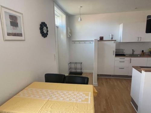 a kitchen with a table and chairs in a room at Cozy base near the cathedral in Viborg