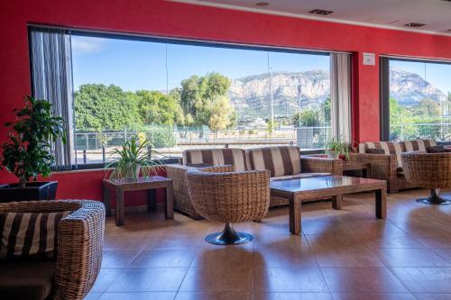 a restaurant with chairs and tables and a large window at Nou Avenida in Gata de Gorgos