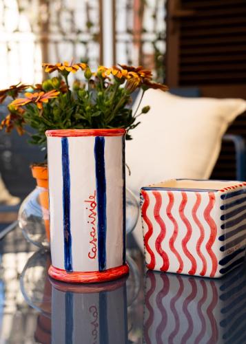 two cups sitting on a table with a plant at Casa Iside in Ladispoli