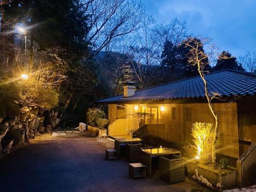 a house with lights on the side of it at night at Hakonesaryo Kintoki in Hakone