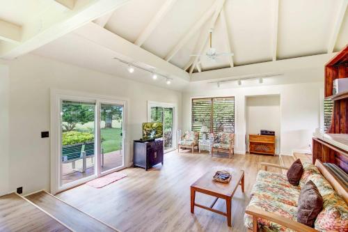 a living room with a couch and a table at Hale Kamalani Mountain Villa and Golf Course Views in Princeville