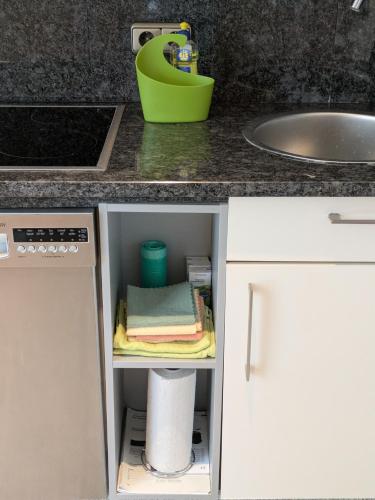 a kitchen counter with a sink and white cabinets at Apartment in Minden-Nordstadt in Minden