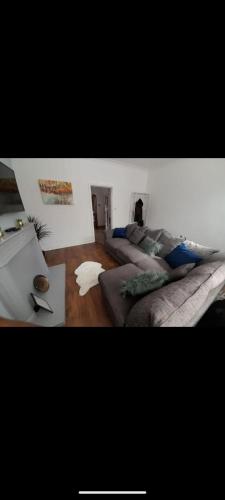 a living room with two beds and a table at Guest Rooms in Bishop Auckland in Bishop Auckland