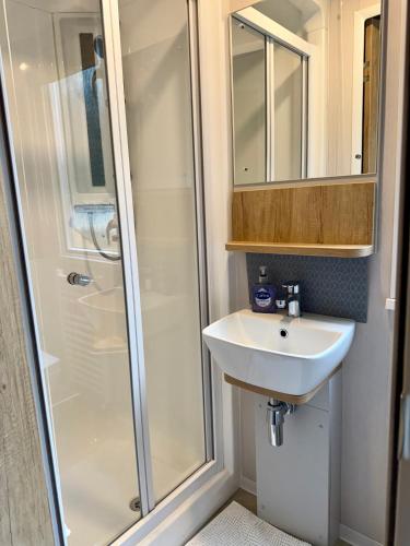 a bathroom with a shower and a sink at The Cooper's Van - Beautiful, luxury static caravan in Aberlour