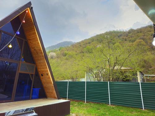 a house with a large window and a fence at Xalxal Luxe Lodge in Oghuz