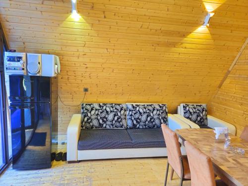 a living room with a couch and a table at Xalxal Luxe Lodge in Oğuz