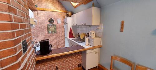 a kitchen with a brick wall and a counter top at Livonia Matkamaja in Kilingi-Nõmme