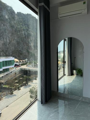 a building with a large window with a view at Táo Homestay in Ha Long