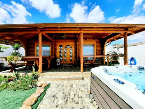 a wooden house with a bath tub in a yard at Wild House in Las Palmas de Gran Canaria