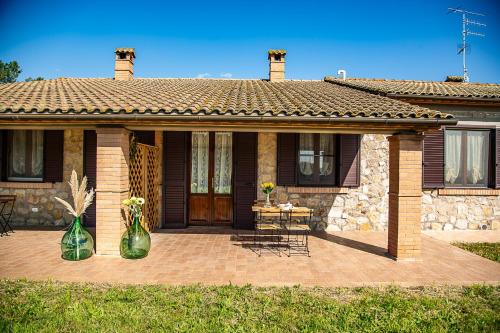 a house with two green vases on a patio at Agriturismo Le Chiocciolaie Appartamento 1 - Appartamento 3 in Podere Cernaia