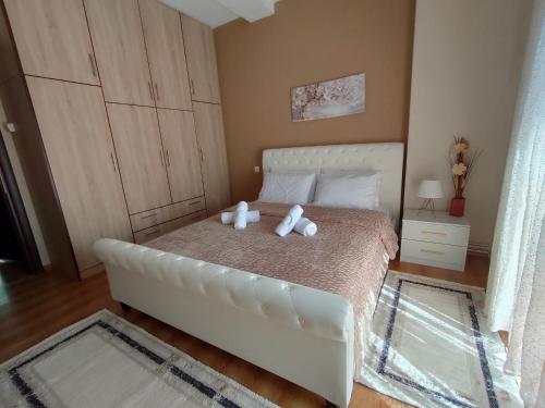 a bedroom with a bed with two teddy bears on it at Crestio apartment Καστοριά in Kastoria