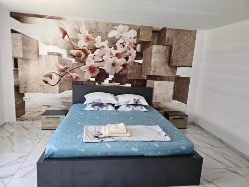 a bedroom with a bed with a floral wall at Casa Andreea in Corbu