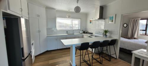 a kitchen with a table and chairs in a room at Seascape Retreat in Riverton
