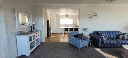 a living room with a couch and a chair and a table at Seascape Retreat in Riverton