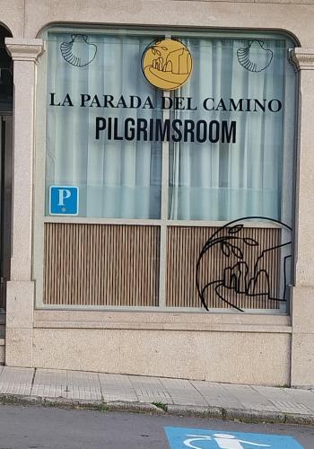a store window with a sign on the front of it at PILGRIMSROOM la Parada Del Camino in Negreira
