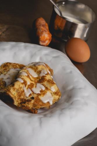 a pastry on a plate with an egg on a table at Sant'Angelo, Matera - Small Luxury Hotels in Matera