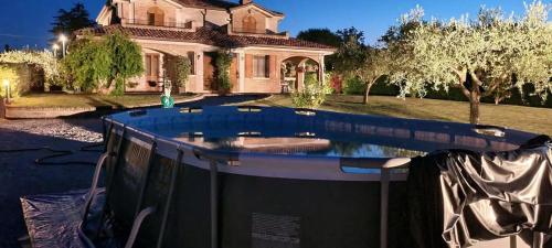 a house with a swimming pool in front of it at Appartamento in villa Gra&Mary in San Giovanni in Marignano
