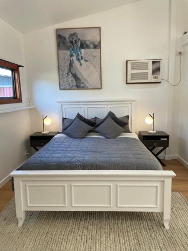 a bedroom with a bed with a blue comforter at Spa Retreat Glenelg East in Glenelg