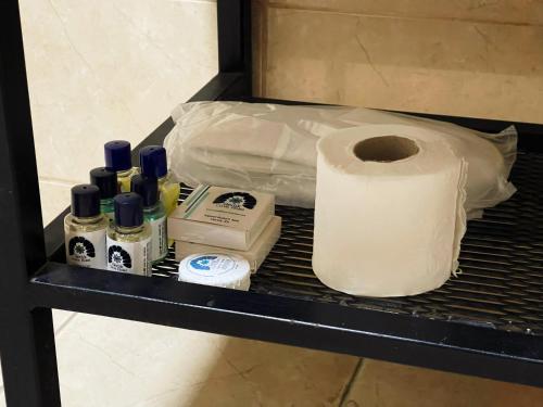 a shelf with a roll of toilet paper and a bag at Gedik Cave Hotel in Goreme