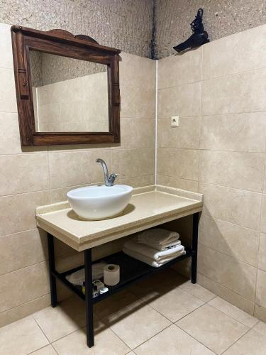 a bathroom with a sink and a mirror at Gedik Cave Hotel in Goreme