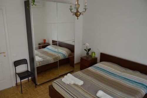 ローマにあるApartment Veioのベッドルーム1室(ベッド2台、鏡付)