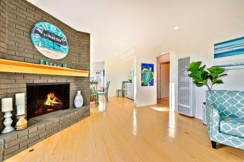 a living room with a fireplace and a couch at Ocean Views Walk to the Beach with King Suite in Encinitas