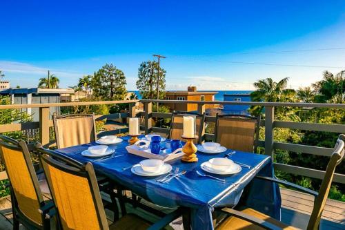 a blue table on a balcony with a view of the ocean at Ocean Views Walk to the Beach with King Suite in Encinitas