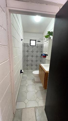 a bathroom with a toilet and a sink at Casita El Zacatal in San José del Cabo