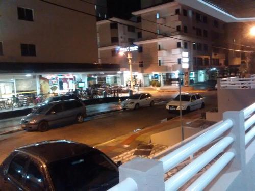 a group of cars parked on a city street at night at Santoro Gali 210 in Florianópolis