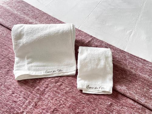 two white towels sitting on top of a table at casa da vila 33 in Faro