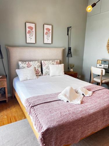 a bedroom with a large bed with two pillows on it at casa da vila 33 in Faro