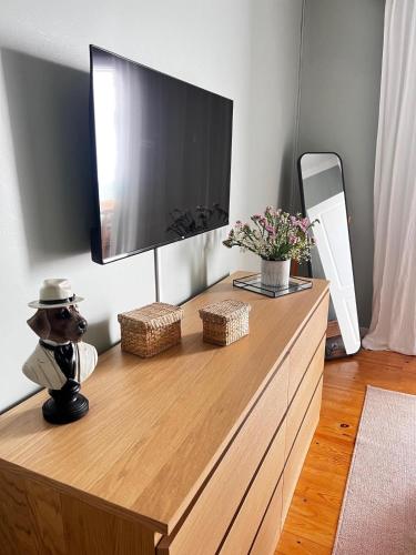 a tv on top of a wooden dresser in a room at casa da vila 33 in Faro