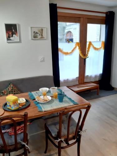 a wooden table with food and drinks on it at Gîte de séjour et d'étape l'Escampette in Saint-Jean-du-Bruel