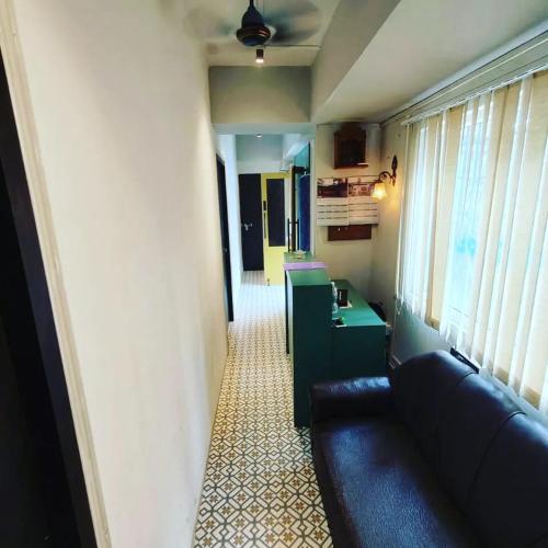 a living room with a couch and a table in a room at Blooming Rooms in Guwahati