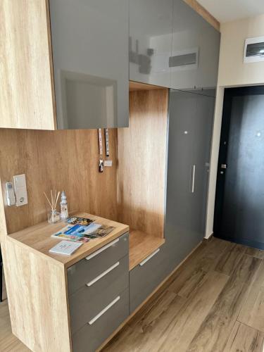 a kitchen with a wooden counter top and wooden floors at Sailor's Panorama Apartment in Alsóörs