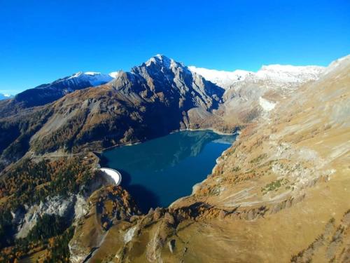 an aerial view of a lake in the mountains at Himalayan vibes in Icogne