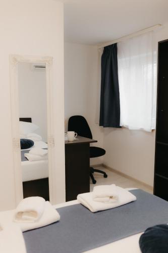 a bedroom with a mirror and a desk and a chair at Pensiunea Pictorilor in Baia Mare